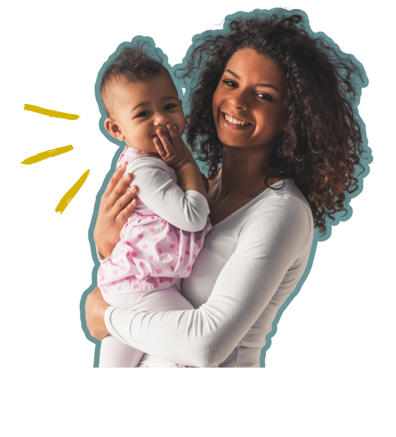 Woman smiling while holding an infant