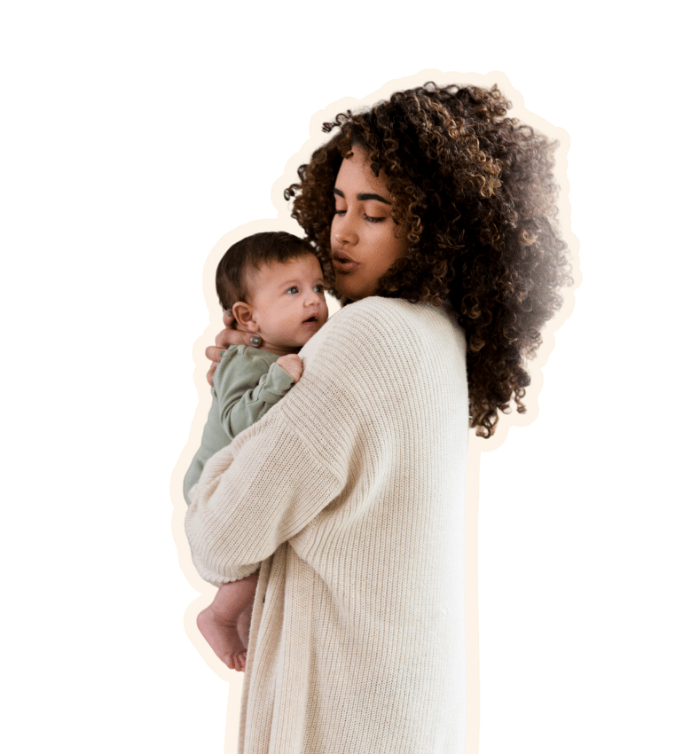 A woman with curly hair holding and sushing a baby