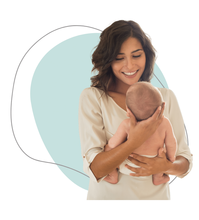 A woman holding her baby and smiling